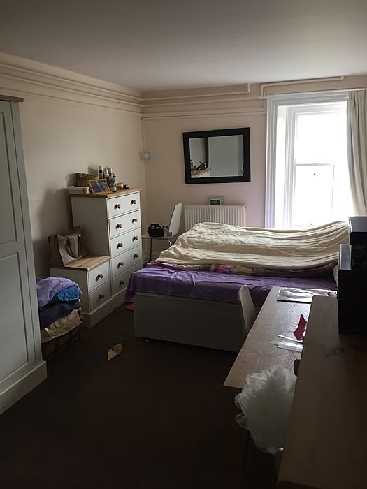 Room with a bed and a press
