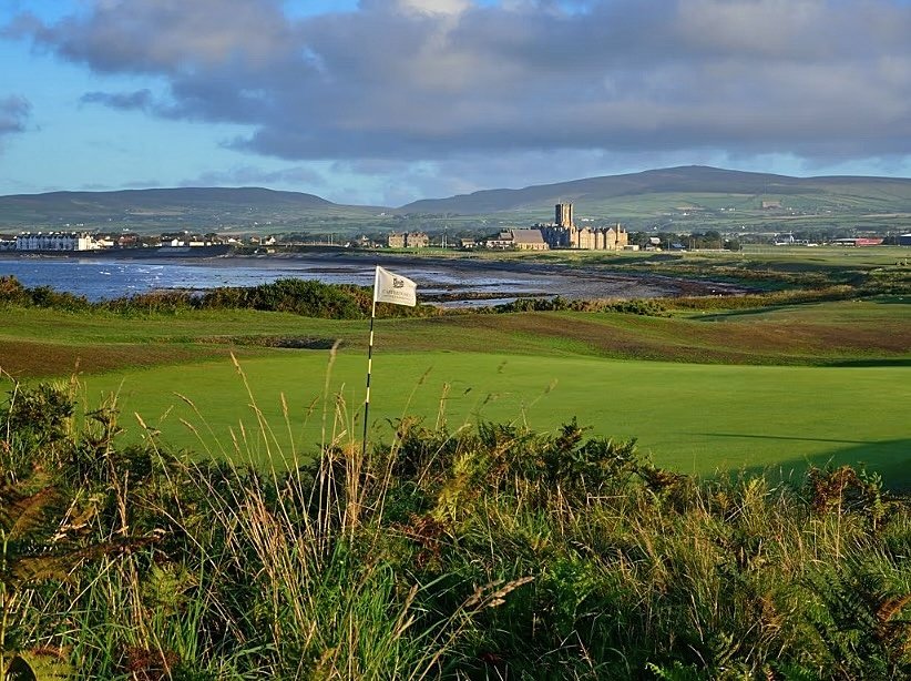 Golf course and in the background a school and hills