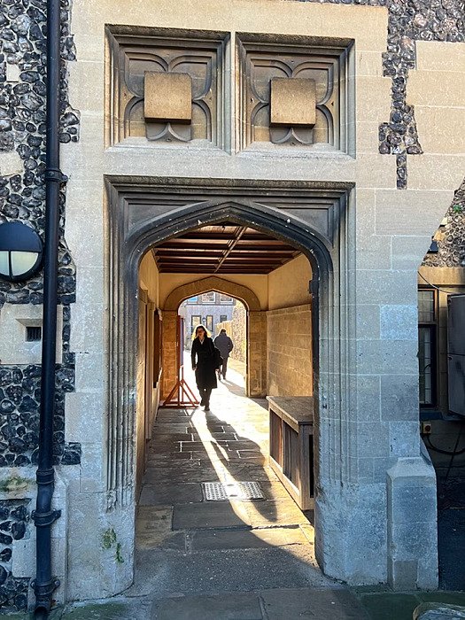 a beautiful sun flooded stone archway at King's School Canterbury