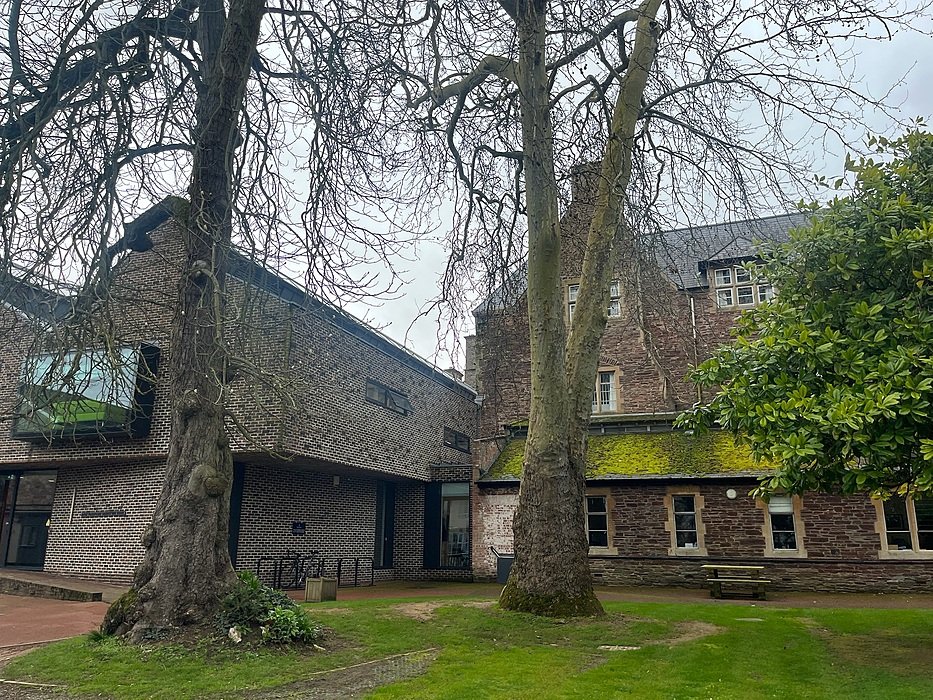 Historic school building with courtyard and mature trees on British boarding school campus