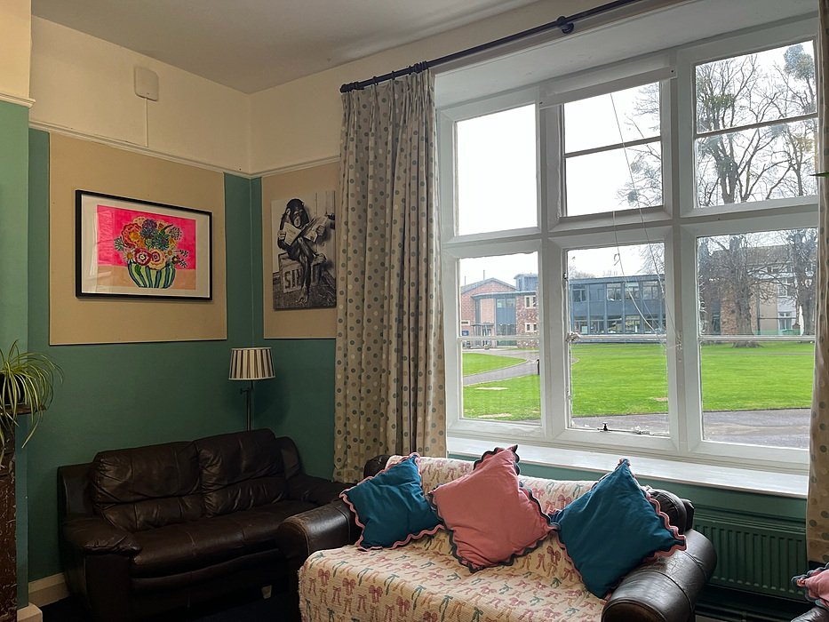 Lounge with sofa and views over green school campus