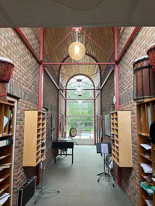 Interior space with brick walls and high ceiling used for study or relaxation
