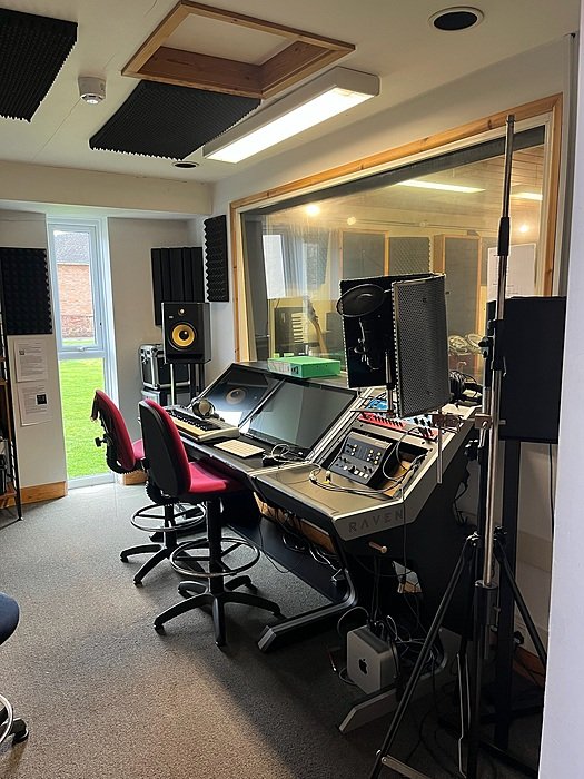 Professional recording studio with mixing desk for music production at boarding school