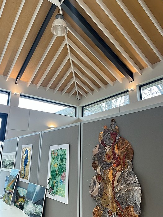 Bright art studio with vaulted ceiling and displayed artwork