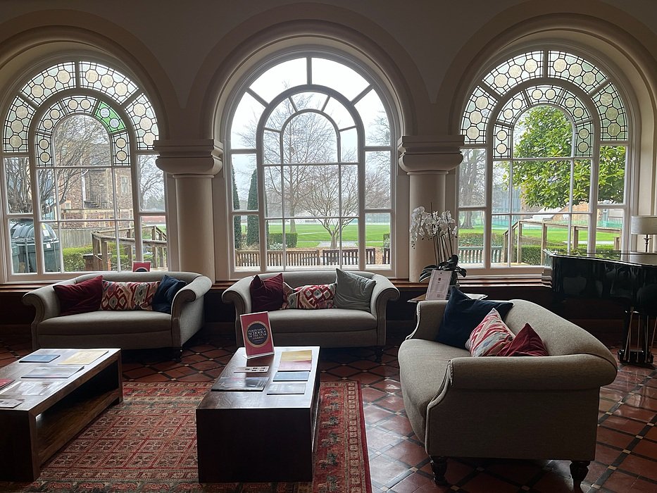 Elegant lounge with large windows overlooking school grounds