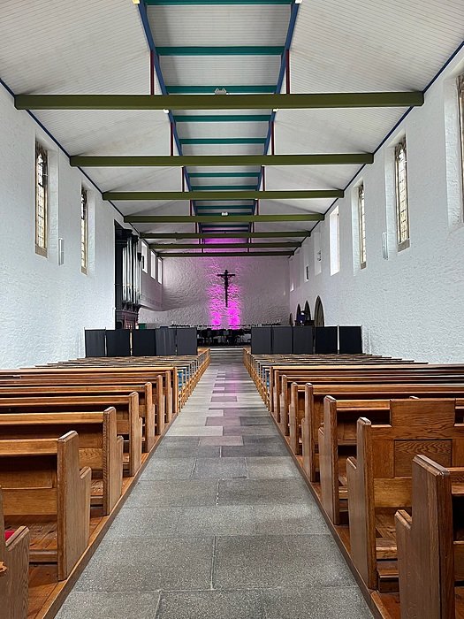 Boarding school chapel with wooden pews and modern altar