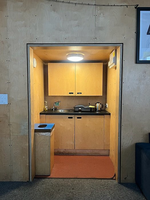 Boarding house kitchenette with cabinets, sink and modern design