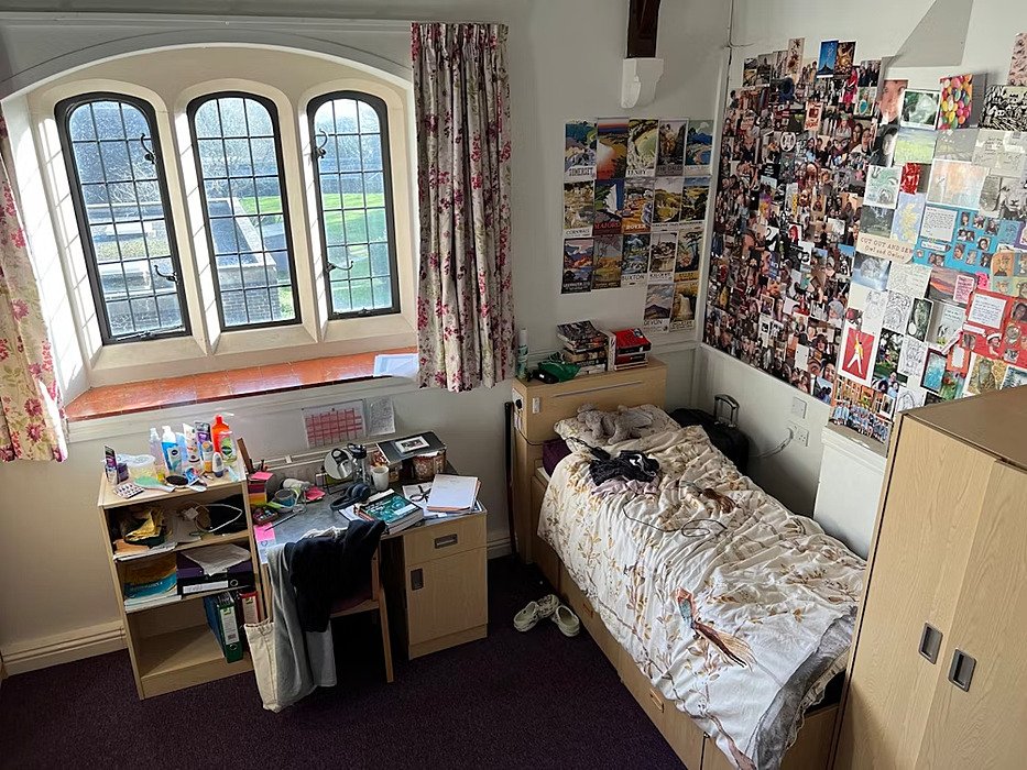 A single room in a boarding house with beautiful old windows overlooking the campus