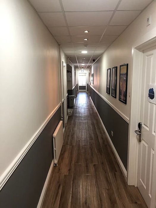 A hallway with brown and white walls