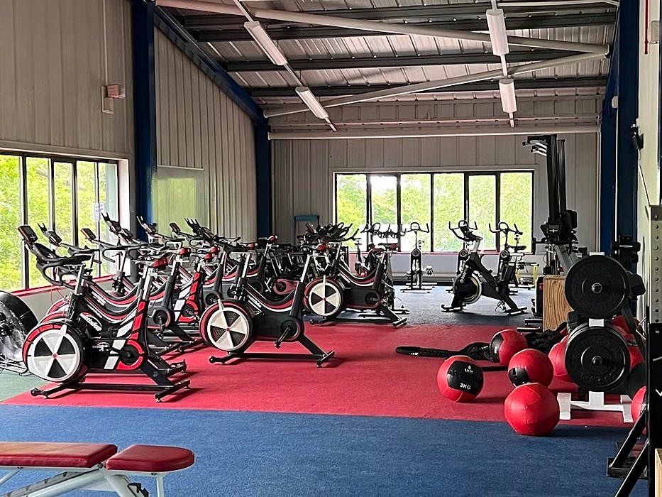 The school's gym with lots of fitness bikes and weights