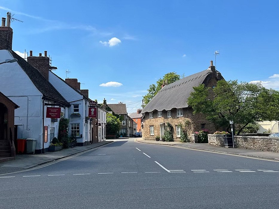 a village road with lovely old houses