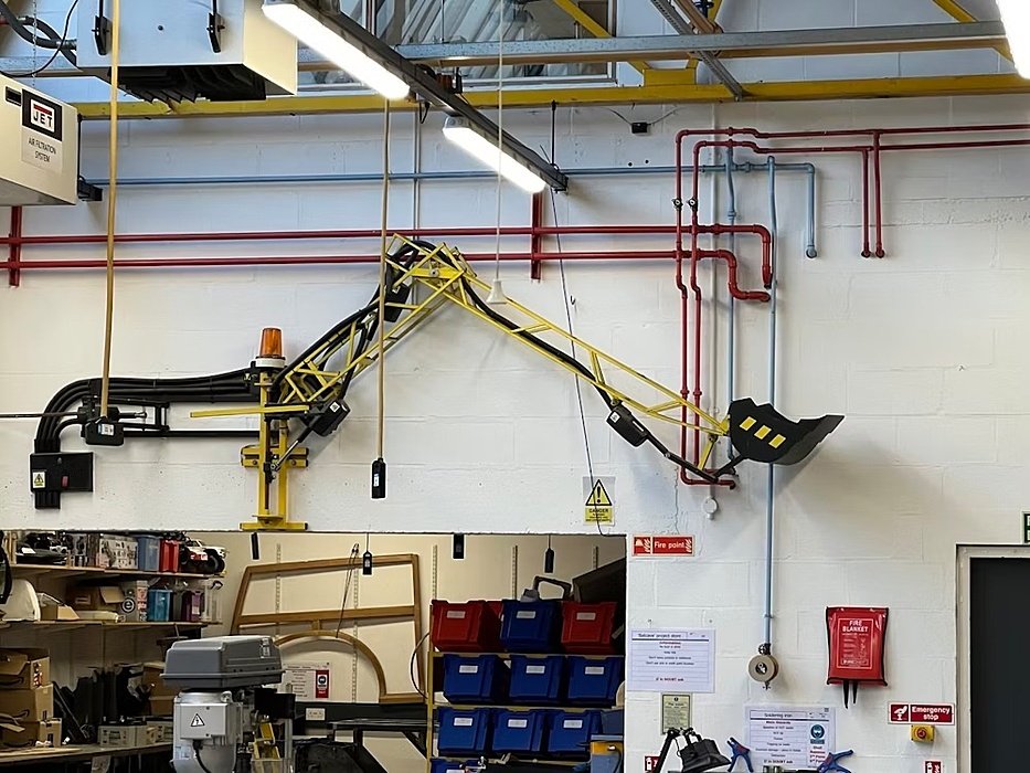 A wall-mounted jib crane in a large workshop.
