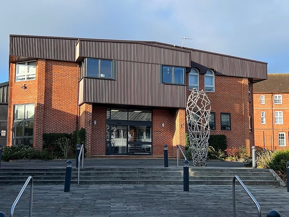 A brick-wooden building with steps infront of it