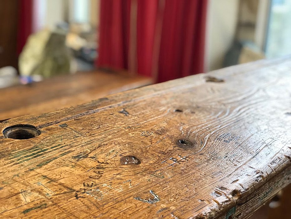 Detail shot of a wooden class table with carved in words from former pupils