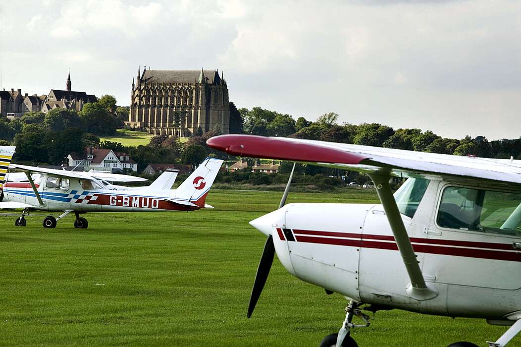two seater aeroplanes on the green of Lancing's Campus for flying lessons as part of Bede's Summer School