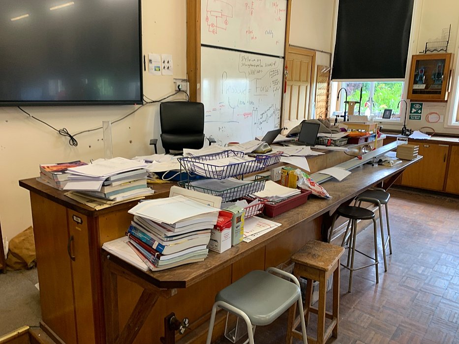 Classroom with teacher’s desk and whiteboard.