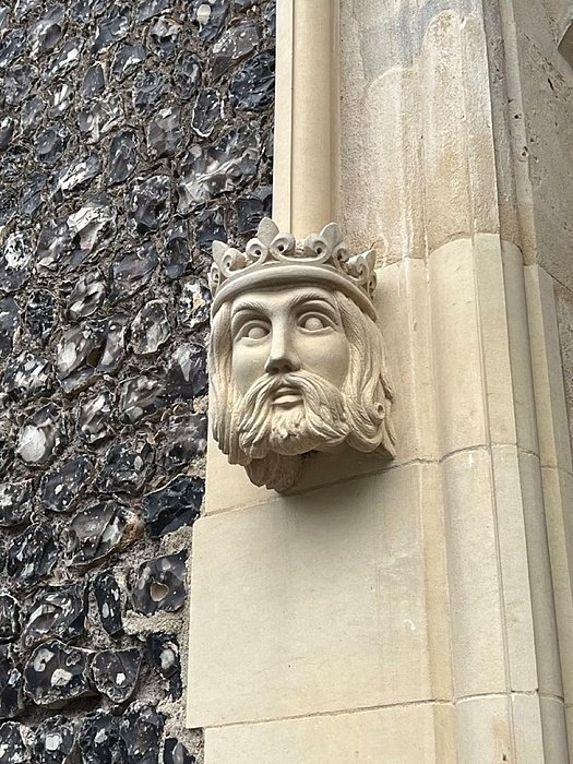 Pillar ornament of a male head with a crown on Brighton's campus