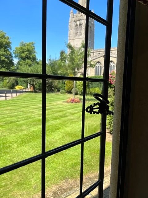 Sunny view from a window at Oakham School onto the green campus