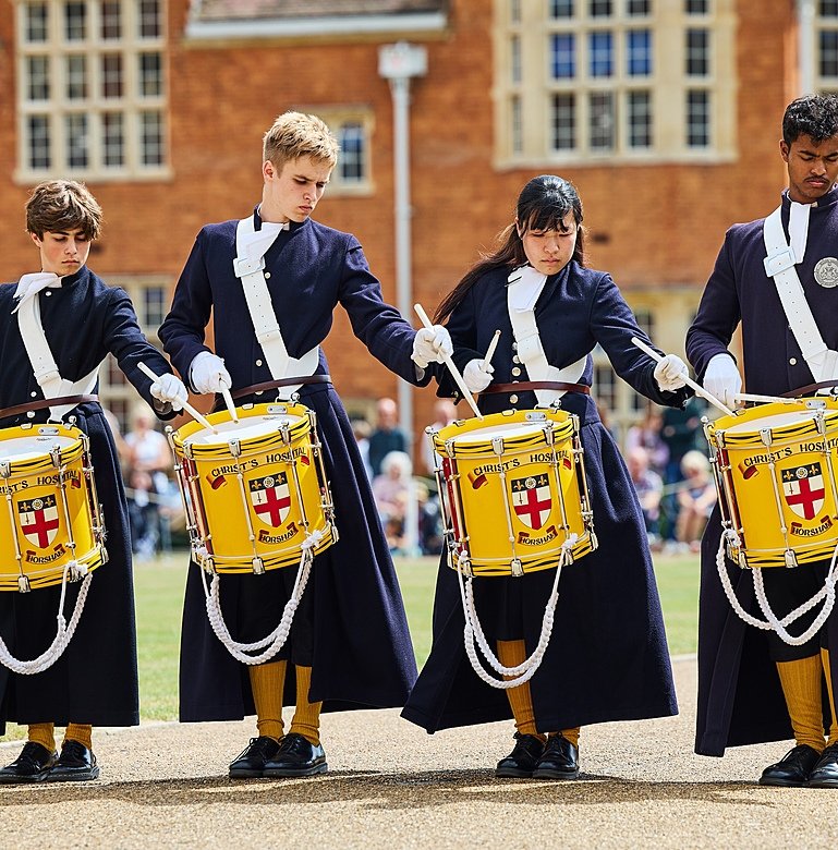 Student drum corps performing in parade at UK boarding school