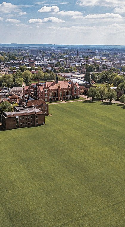 Aerial view of school campus with lots of green lawn on a summery day