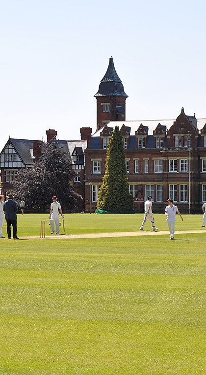 Dean Close School with students playing Cricket in the front