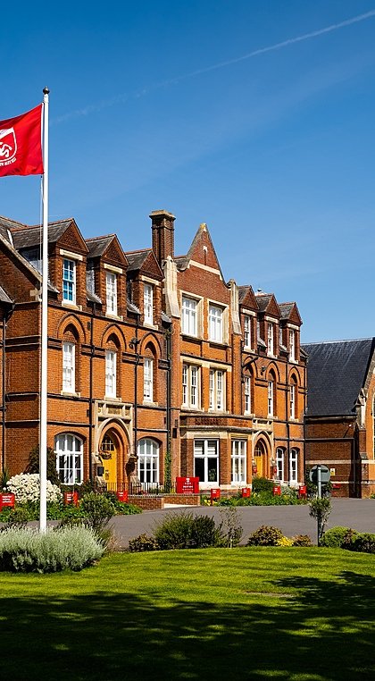 Kent College's red bricked main school building from the front