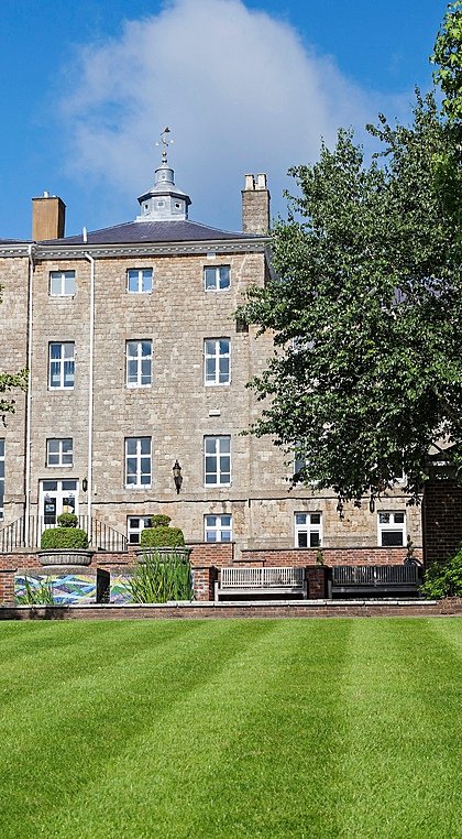 The main building of Sevenoaks School surrounded by its green campus
