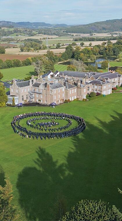 Areal view of Strathallan School and campus with students outside lined up in a big circular formation