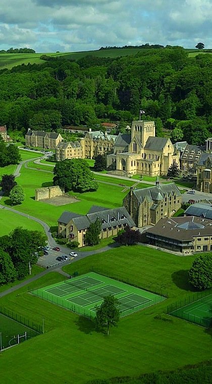 Aerial shot of rural school campus in green fields