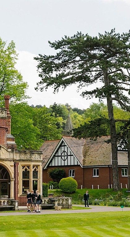 Red-brick manor house with Victorian stone cladding, tree to the right