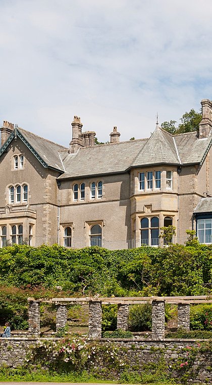 Historic stone school building with gardens at Windermere School.