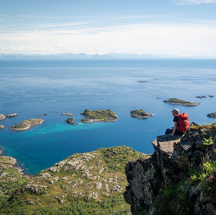A Gordonstoun pupil sitting on a cliff overlooking a gorgeous Scottish bay