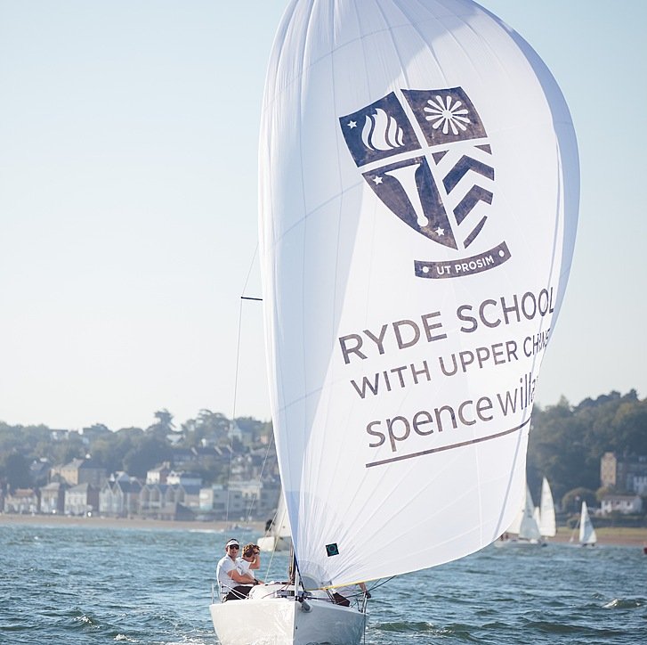 one of the schools sailing boats with students during their sailing lessons