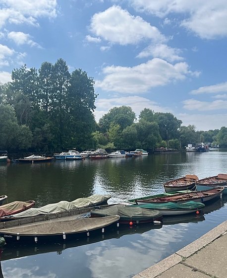 belayed boats on the water lined up along the river Thames