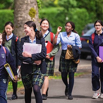 Six school girls laughing on their way