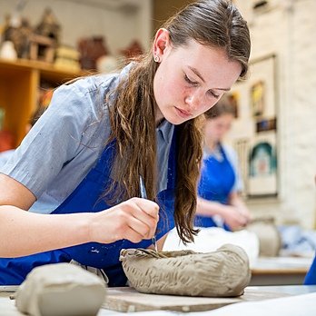 A girl doing a pottery project