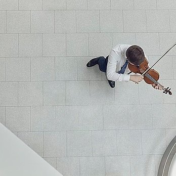 A student playing the violin, seen from above