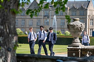 Pupils walking along Canford School campus in sunny weather