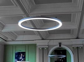big circular ceiling lights underneath an old pretty ceiling at Royal Hospital School