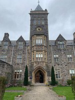 Historic stone school building with clock tower