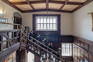 Students walking down an old wooden staircase at Framlingham College