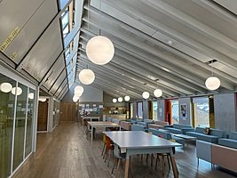 Tables with chairs and sofas with coffee tables in the attic of the school