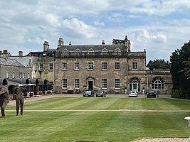 Historic college with large front lawn and Georgian architecture.