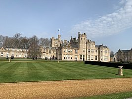 Historic boarding school building with large lawn and classic architecture