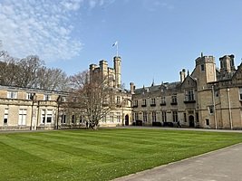 Historic boarding school building with large lawn and classic architecture
