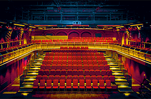 The stunning Malvern College Theatre with red seats and its upper circle