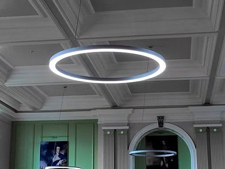 big circular ceiling lights underneath an old pretty ceiling at Royal Hospital School