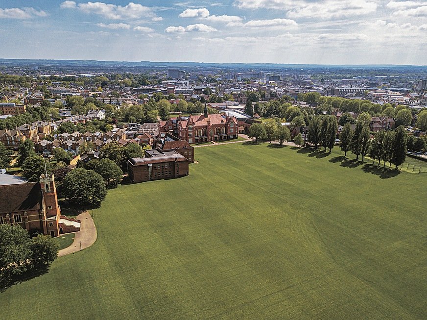 Aerial view of school campus with lots of green lawn on a summery day