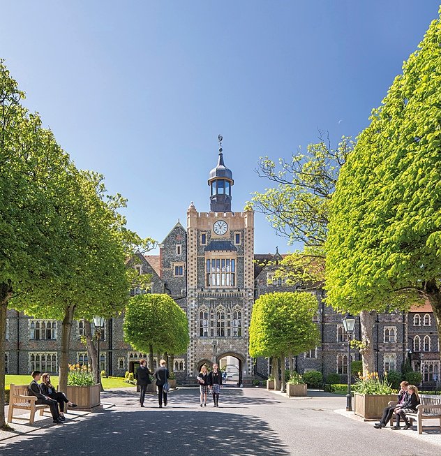 Students on the Brighton College campus with the main building in the background