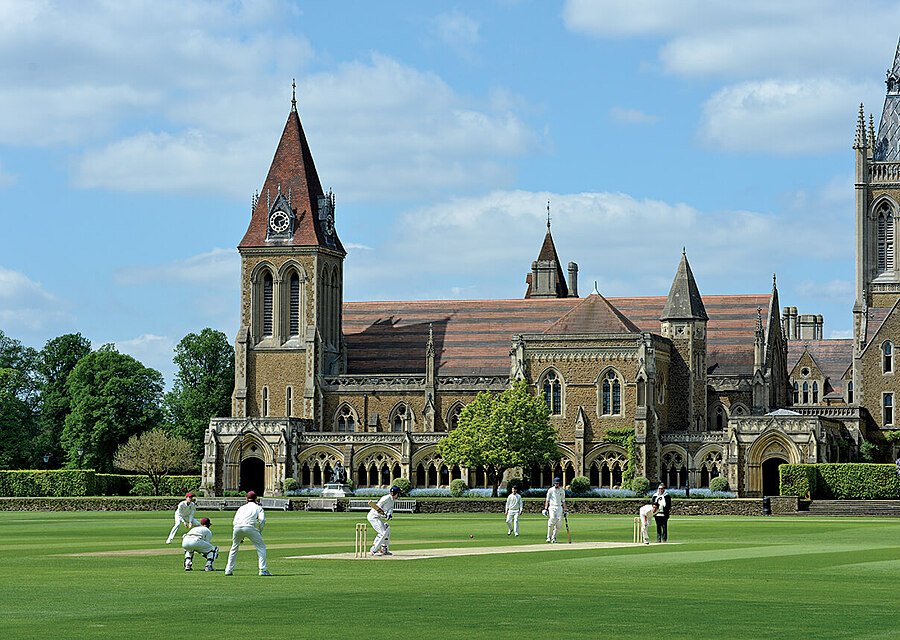 Students playing cricket in front of Charterhouse School